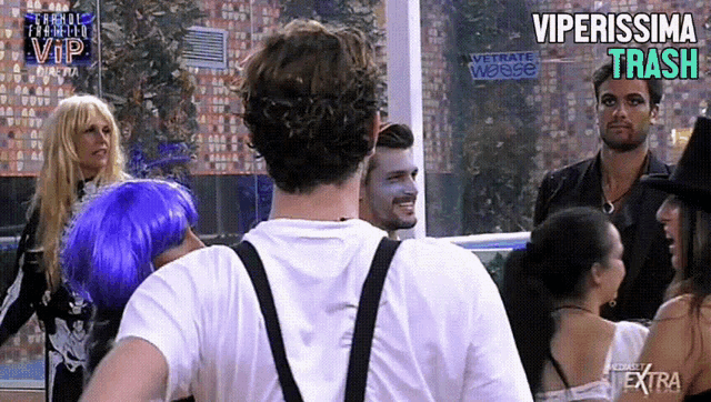 a group of people standing in front of a sign that says vetrate weisse