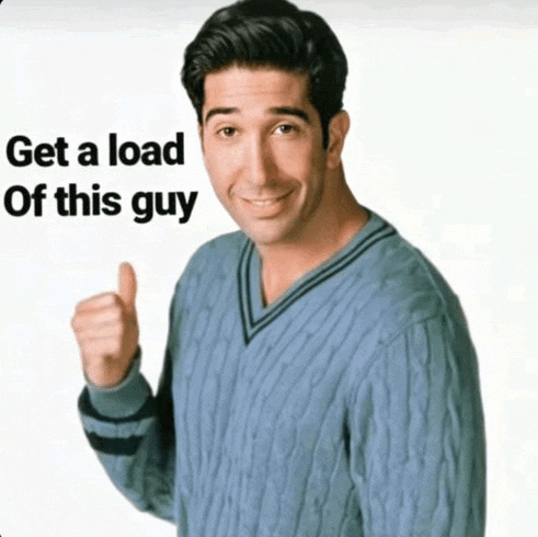 a man in a blue sweater giving a thumbs up with the words get a load of this guy behind him