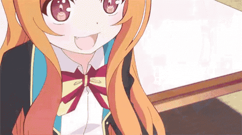 a girl with long orange hair and a bow tie is sitting at a table .
