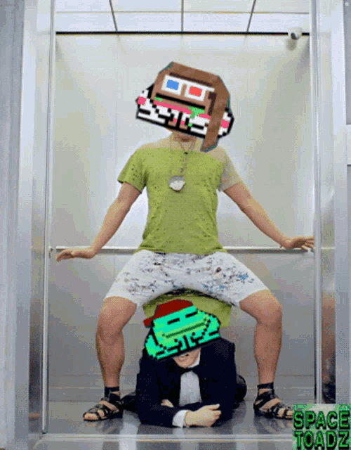 a man in a green shirt is sitting on another man 's head with a space toadz logo behind him