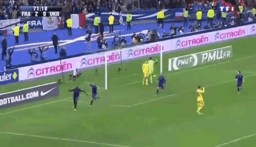 a soccer game is being played on a field sponsored by citroen and pmu.fr