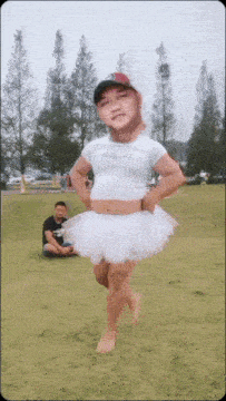 a man wearing a tutu and a crop top stands in a field