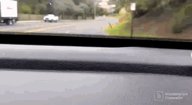 a white truck is driving down a road next to a sign that says no parking