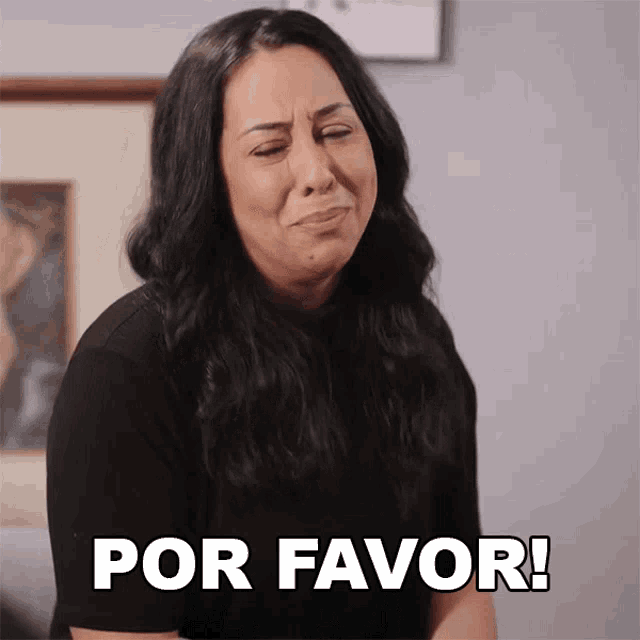 a woman in a black shirt is making a face and says por favor