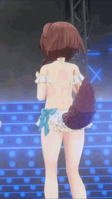 a girl in a bikini is standing on a stage with a dog tail .