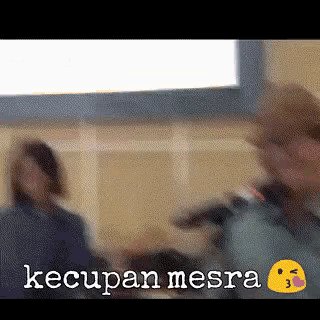 a blurred image of people with the words " kecupan mesra " written on the bottom