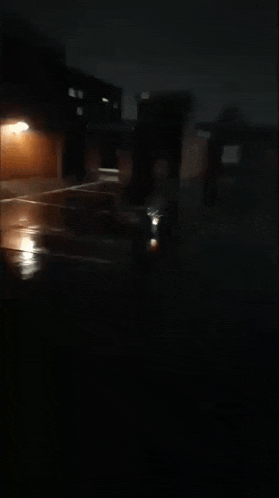 a dark parking lot with a few lights shining on it