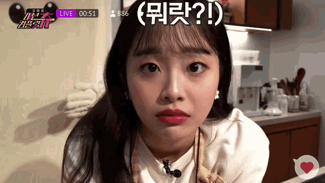 a woman 's face is shown in front of a screen that says live on it