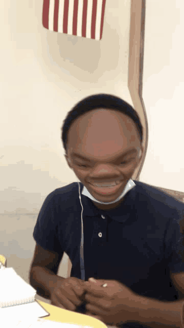 a young man wearing a mask and headphones is smiling