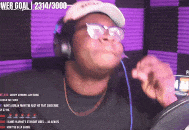 a man singing into a microphone with a web goal of 2314/36000