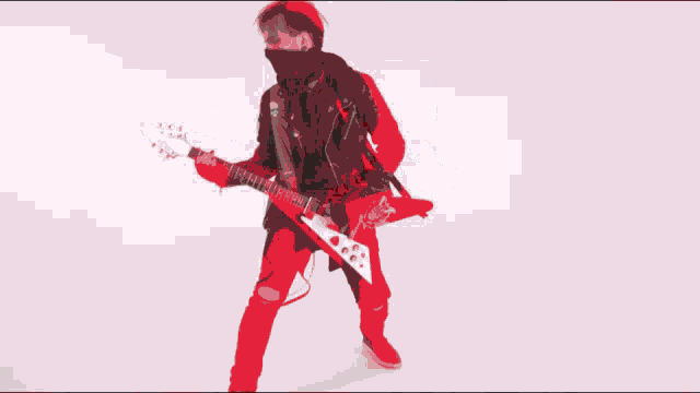 a man in a black jacket and tie is playing a guitar