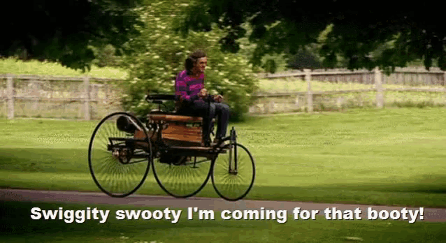 a man is riding a bicycle on a path with the words swiggity swooty i 'm coming for that booty