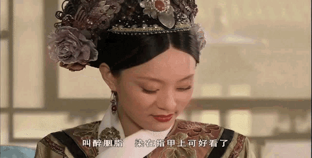 a woman wearing a crown and earrings has chinese writing on her chest