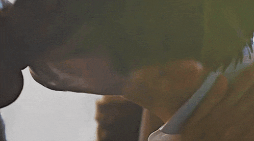 a close up of a man 's face with a tear coming out of it .