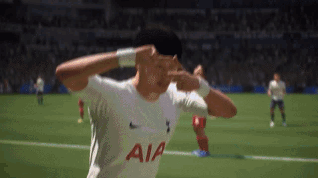a soccer player wearing an aia jersey is making a funny face