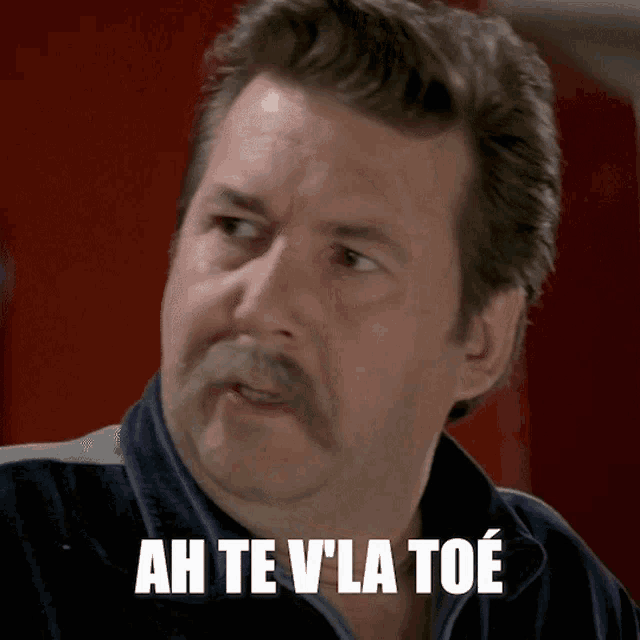 a man with a mustache and the words ah te vla toe on his face