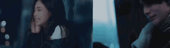 a man and a woman are sitting next to each other in a dark room .