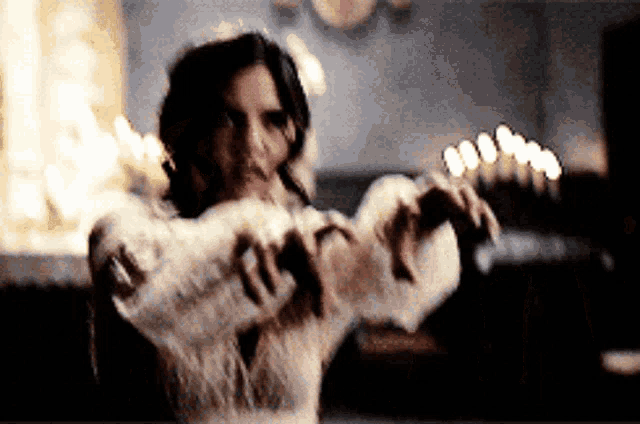 a woman in a white sweater is holding a bottle in her hands