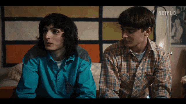 two young men sitting next to each other with a netflix logo on the bottom right