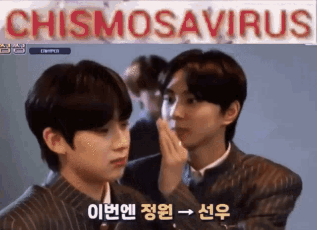 two young men are standing next to each other with a sign above them that says chismosaurus