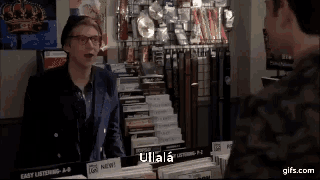 a man talking to another man in front of a sign that says ullala