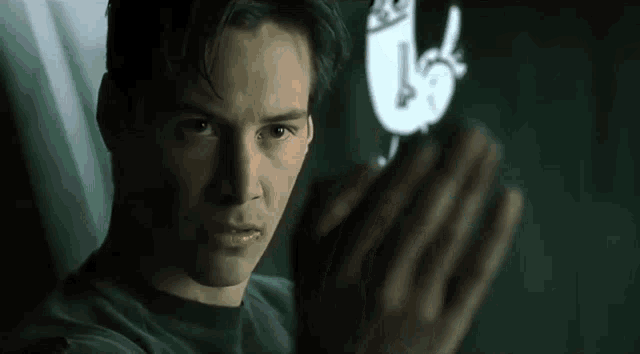 a man in a black shirt is looking at a drawing of a hand on a screen