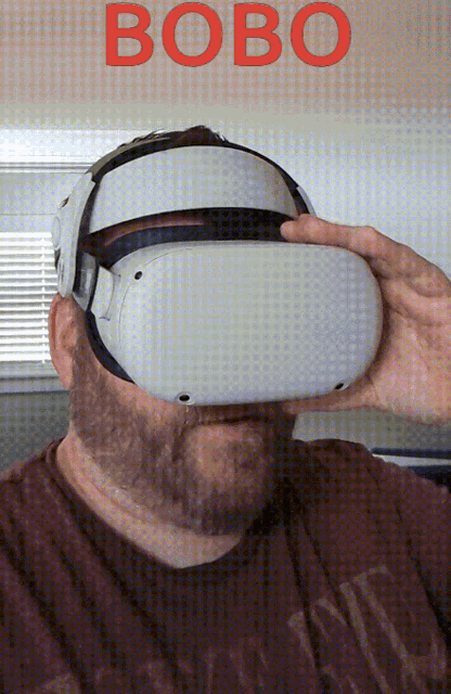 a man wearing a virtual reality headset with the word bobo written in red