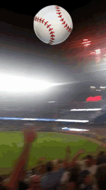 a baseball is being thrown in the air by a crowd