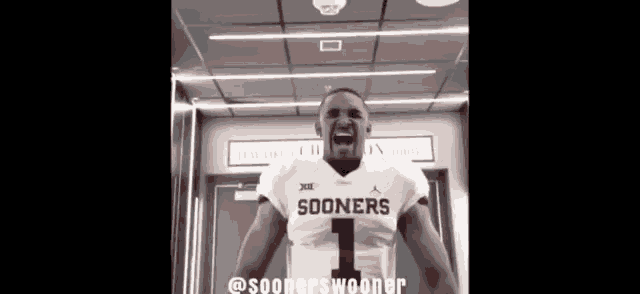 a football player wearing a sooners jersey is standing in a locker room