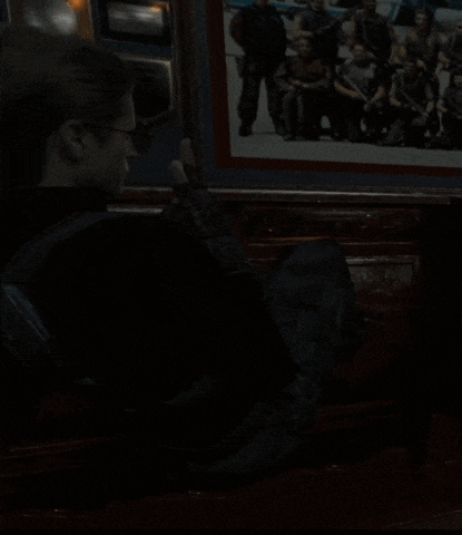 a dark room with a picture of a group of men