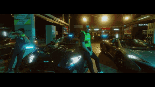 a man in a yellow vest stands in front of a car that says 50 on it