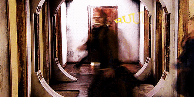 a blurred image of a person in a hallway with the word ru on the wall
