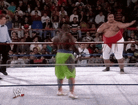 two wrestlers in a wrestling ring with a w logo on the ground