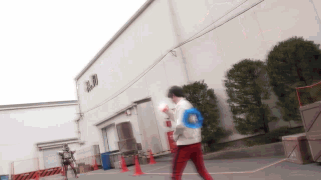 a man is walking in front of a building that says r & d