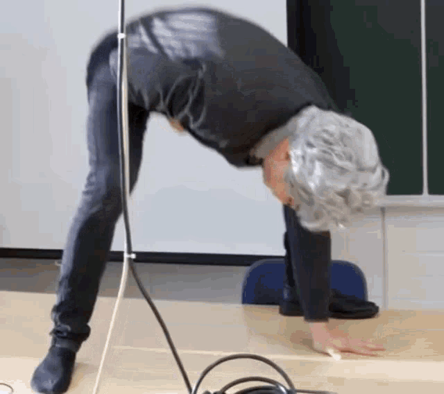 a person is doing a handstand on a desk