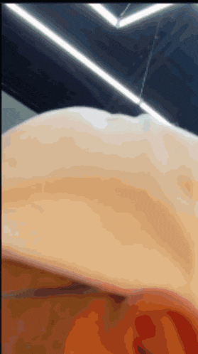 a close up of a person 's torso with a light behind it