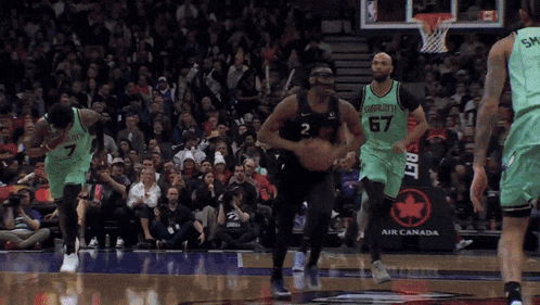 a basketball game is being played in front of an air canada banner