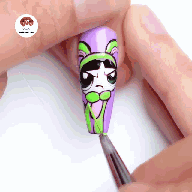 a close up of a person 's nails with a picture of a cartoon character on it