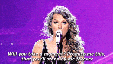 a woman singing into a microphone with the words will you take a moment promise me this