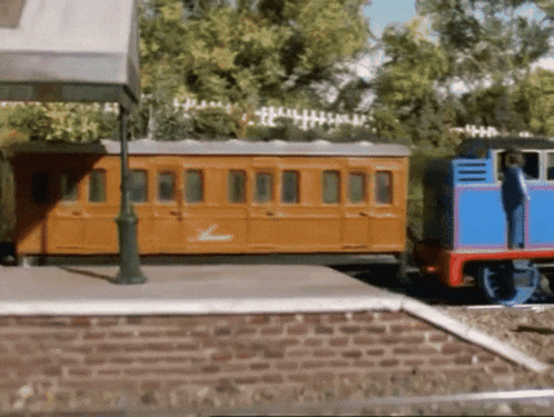a blue and orange train with the word thomas on the side