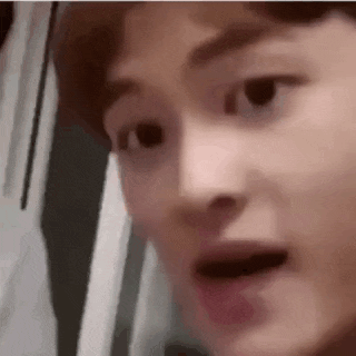 a close up of a man 's face with a surprised look on his face .