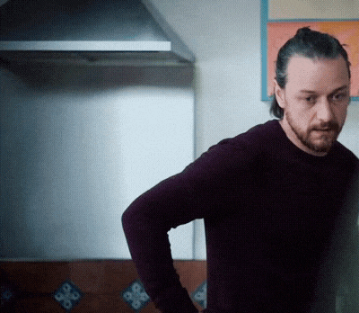 a man with a beard is standing in a kitchen