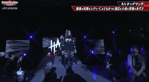 a woman is holding a blue object in front of a sign that says stardom on it