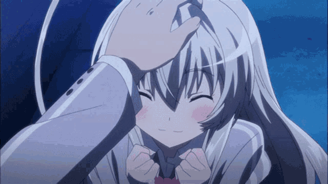 a person touching a girl 's head with a hand