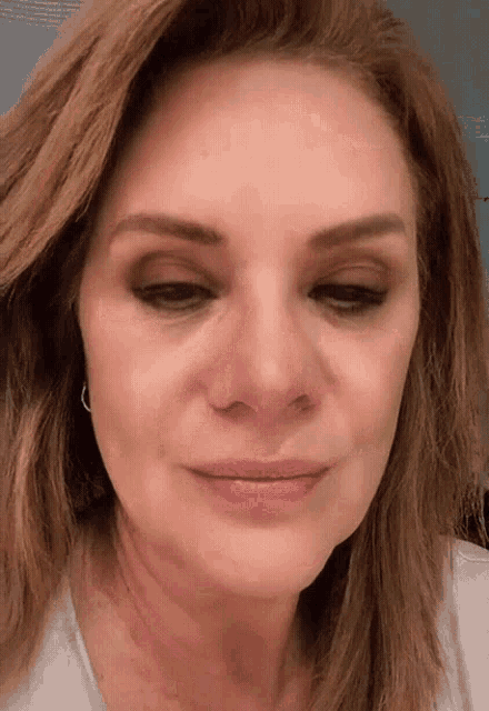 a close up of a woman 's face with a smile on her face