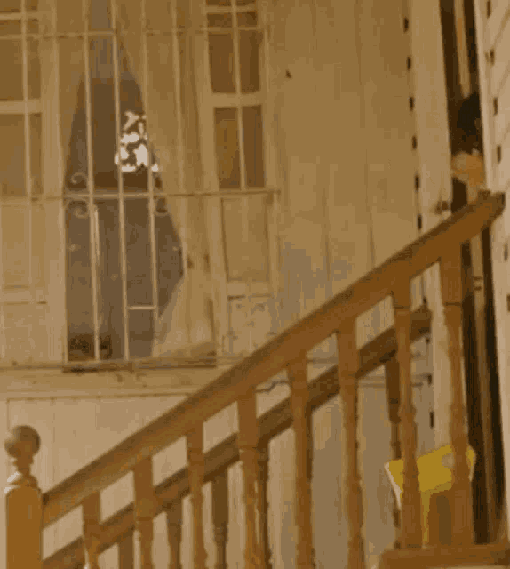 a woman is standing on a set of wooden stairs