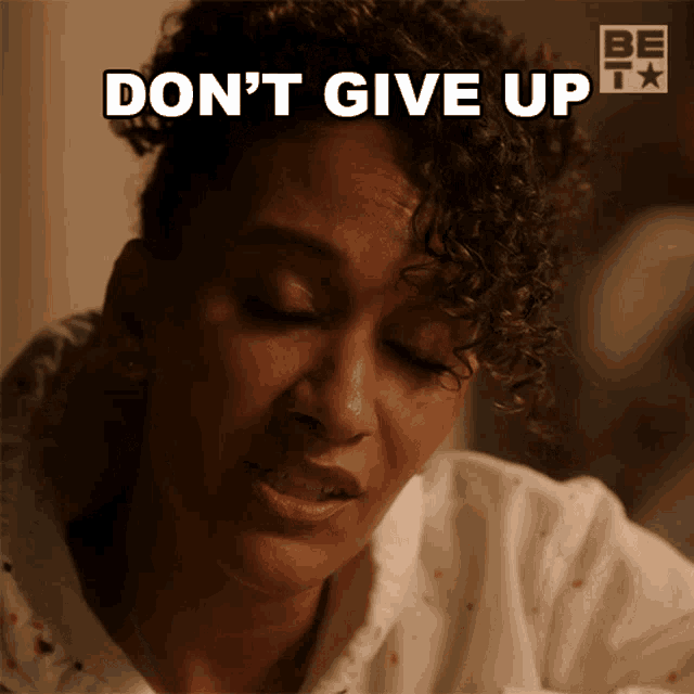 a woman with curly hair says " do n't give up " in white letters