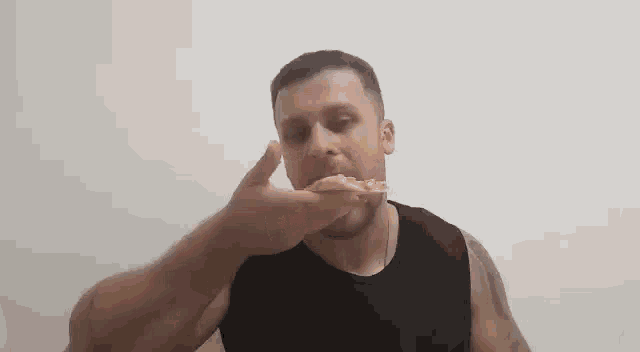 a man is eating a slice of pizza .