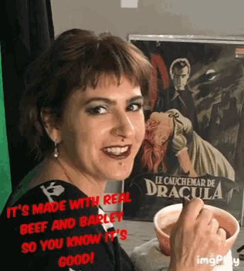 a woman is smiling in front of a poster that says dracula