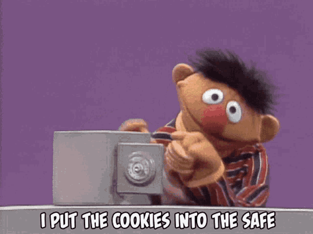 ernie from sesame street is holding a safe and says " i put the cookies into the safe "